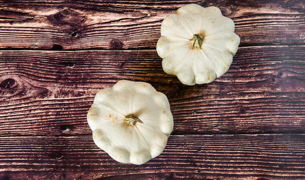 patison pumpkin squashed on dark kitchen table, whole bio raw vegetable brom village gardening