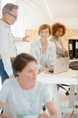 Fototapeta premium Office workers talking at desk