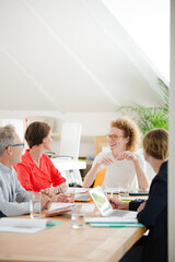 Office workers talking at desk