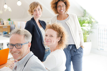 Fototapeta premium Office workers talking and smiling at meeting