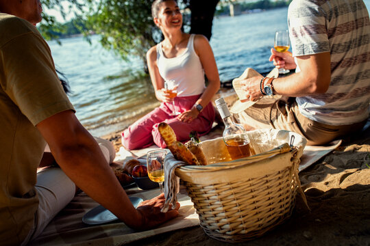 Diverse group of friends enjoying picnic by the river.