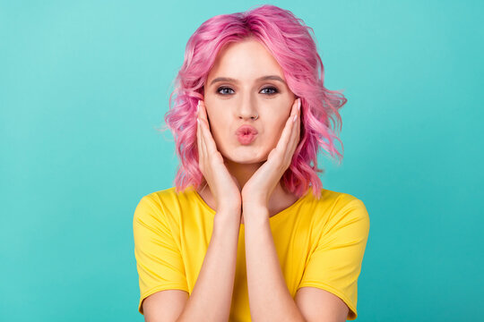 Photo of millennial flirty pink hairdo lady hands cheeks blow kiss wear yellow t-shirt isolated on teal background