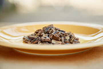 Carob - plant-based alternative - natural product on the plate. Organic antioxidants and protein. Copy space