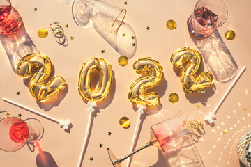 Gold balloons 2022, champagne glasses Concept fun New Years party