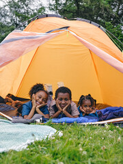 Siblings lying in tent