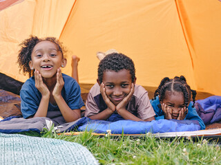 Siblings lying in tent © Cultura Creative