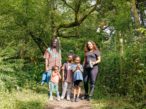 Portrait Of Family With Children In Forest