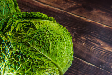 Fresh bio green garden cabbage on rustic wooden background from farm village gardening.