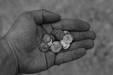 Vintage coins in hand in black and white