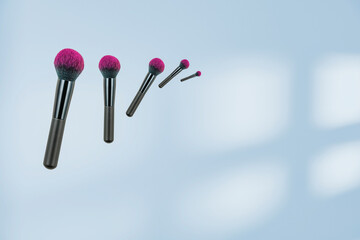Cosmetic brush on the wall with a shadow in the color of blue 