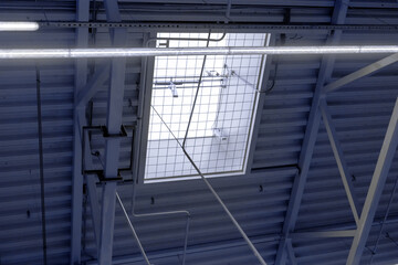 ventilation window with automatic opening in the metal roof of a shopping center or warehouse