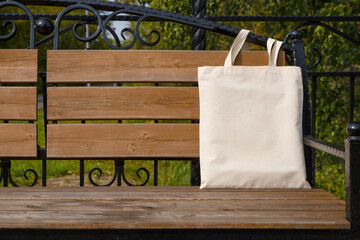 Rustic tote bag on the garden bench mockup