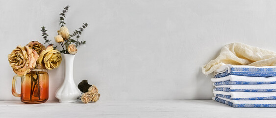  fashionable background of hygiene supplies  and dried flowers in a vase on a white table. Cozy home background.