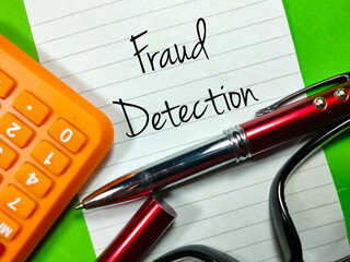 Business concept.Text Fraud Detection writing on notepaper with calculator,glasses and pen on green...