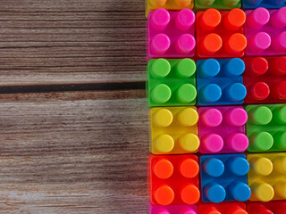 The Color toy bricks  on wood table for background or education concept