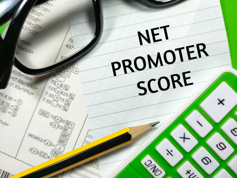 Business concept.Text NET PROMOTER SCORE writing on notepaper with calculate document,glasses,calculator and pencil on green background.