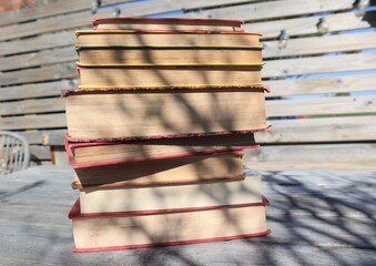 Stack of vintage books in sunshine. Learning and reading