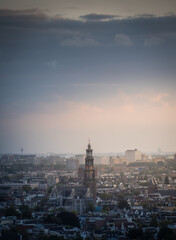 Fototapeta na wymiar Aerial view of the city of Amsterdam, capital of the Netherlands on a calm summer evening, during cloudy sunset
