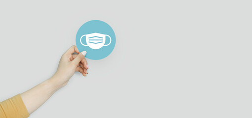 Hand holding blue paper cut with face mask icon, Health care and mental health, cleanliness, safety , world mental health day concept