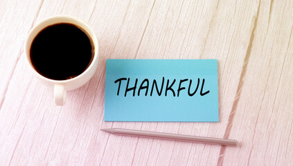 THANKFUL text on the blue sticker with cofee and pen