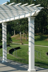Pergola with slatted roof with shadows in public park