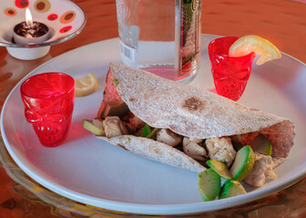 Burrito and tequila-shots set. Mexican food. Red skull shot glasses. Party for two. Colorful.