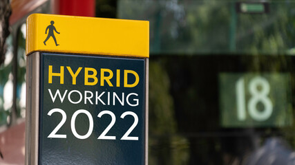 Hybrid Working 2022 sign in a busy commuter city center