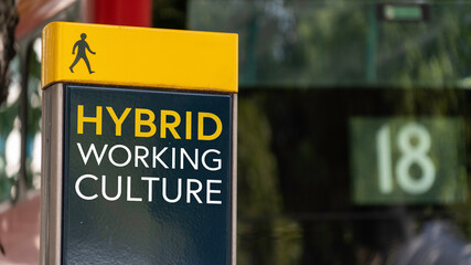 Hybrid Working Culture sign in a busy commuter city center