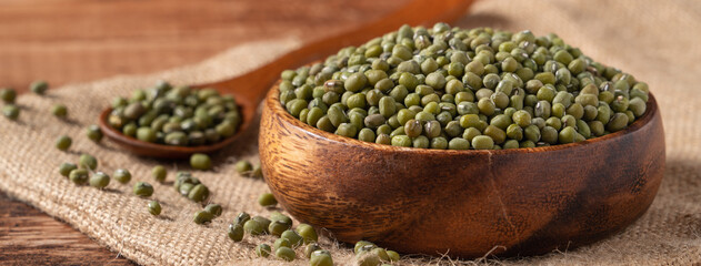 Close up of raw mung bean on wooden table background.