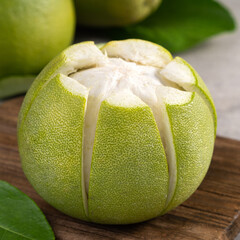 Fresh pomelo fruit on gray cement background.