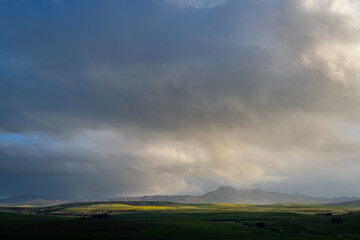 Storm clouds over farmlands and the Wind turbines on the 27 MW Klipheuwel Wind Farm. Near Caldon. Overberg. Western Cape. South Africa