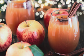 Fresh apple cider drink with star of anise and cinnamon. Selective focus on juice with extreme blurred background and foreground.