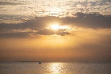Fototapeta na wymiar Beautiful sunset on the sea coast. The rays of the sun are visible.
