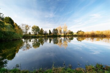 Trees at the pond before sunset. Rouske. Eastern Moravia. Czechia. Europe.