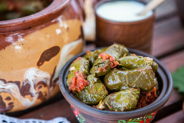 Dolma.Traditional romanian cuisine stuffed cabbage leaves with minced meat and rice in ceramic dish.