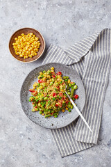 Quinoa salad with green beans, corn, red bell peppers, peas and soybeans. Useful vegetable mix