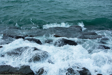 rough sea, cliffs and white foam.