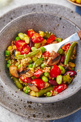 Quinoa with green beans, tomatoes, fried champignons, corn, red bell peppers, peas and soybeans. Healthy Vegetable Mix