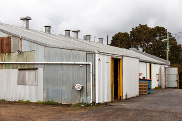 Grey metal warehouse in industrial area.