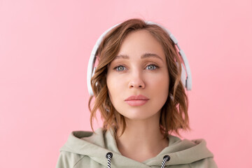 Woman listen music headphones  pink background studio shoot