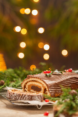 Traditional Christmas cake, chocolate Yule log with festive decorations 