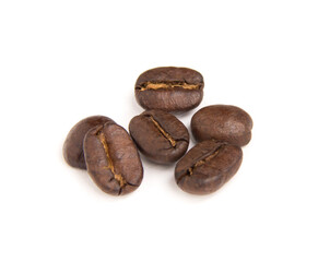 Close up of six roasted coffee beans isolated