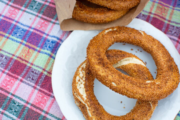 Turkish bagel on a plate and in a paper bag on the table.