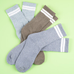 Top view of warm socks on a pistachio-colored background