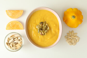 Flat lay with pumpkin soup ingredients on white background