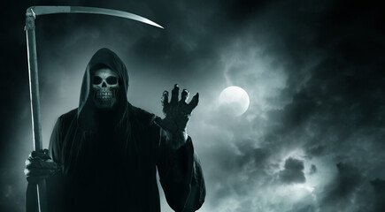 Grim reaper with scythe standing against  cloudy dramatic night sky with moon.The death  in a black hoodie.Halloween card with skeleton.Horror style  fantasy background with copy space.