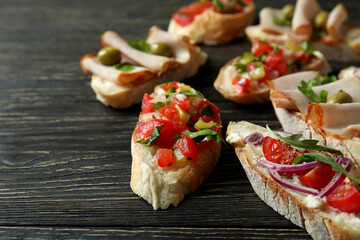 Delicious italian snacks bruschetta on wooden background