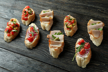 Delicious italian snacks bruschetta on wooden background