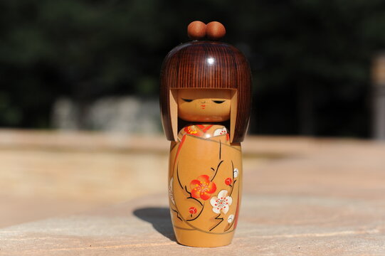 Japanese wooden kokeshi doll in kimono with brown hair