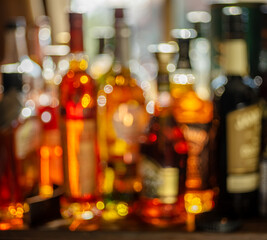 Beautiful bokeh from a row of alcoholic bottles in backlight.
